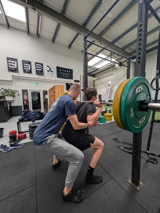 Personal training squat coaching